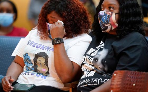 Tamika Palmer, the mother of Breonna Taylor, weeps during a Sept. 15 news conference announcing a $12 million civil settlement between the Taylor's estate and the city of Louisville, Kentucky. (CNS/Reuters/Bryan Woolston)