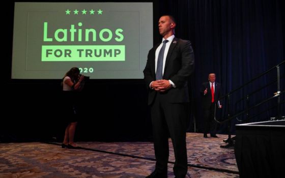 President Donald Trump, right, walks on stage before delivering remarks during a Latinos For Trump campaign event at the Trump National Doral Miami resort in Doral, Florida, Sept. 25, 2020. (CNS/Reuters/Tom Brenner)