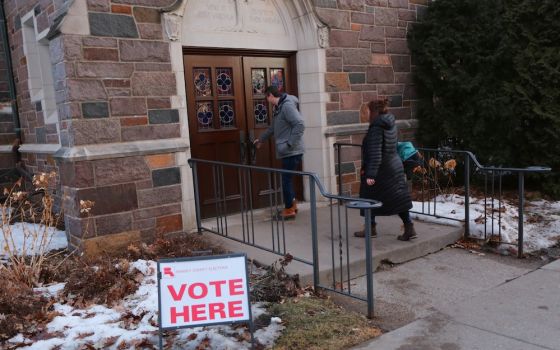 People enter Nativity of Our Lord Church in St. Paul, Minnesota, March 3, when the church served as a polling place for the Super Tuesday presidential primary. (CNS/Catholic Spirit/Dave Hrbacek)