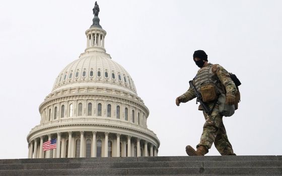 A member of the National Guard walks the grounds of the U.S. Capitol on the second day of former President Donald Trump's second impeachment trial in Washington Feb. 10, 2021. (CNS/Reuters/Kevin Lamarque)