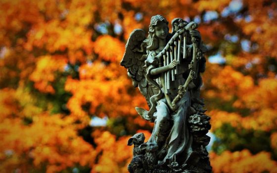 An angel statue set off by fall foliage at St. Margaret's Catholic Cemetery in Neenah, Wisconsin, Sept. 22 (CNS/Brad Birkholz)