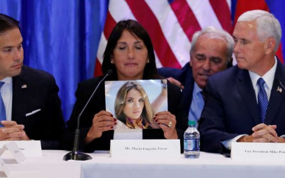 Sen. Marco Rubio, R-Florida, and Vice President Mike Pence listen to Maria Eugenia Tovar Aug. 23 at Our Lady of Guadalupe Church in Doral, Florida, as she holds a picture of her daughter who was killed in 2014 during a protest in Venezuela.