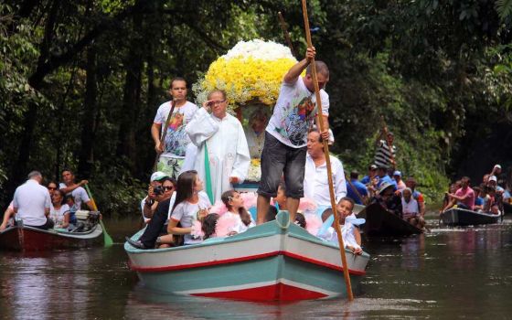 Pilgrims travel in boats as they accompany the statue of Our Lady of Nazareth during an annual river procession and pilgrimage along the Apeu River to a chapel in Macapazinho, Brazil, Aug. 3, 2014. (CNS/Reuters/Ney Marcondes)