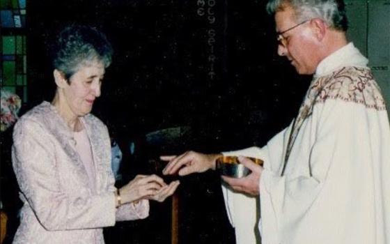 The author's mother, Carmen Nanko, receives Communion from Fr. Robert Poveromo. (Courtesy of Chip and Karen Nanko)