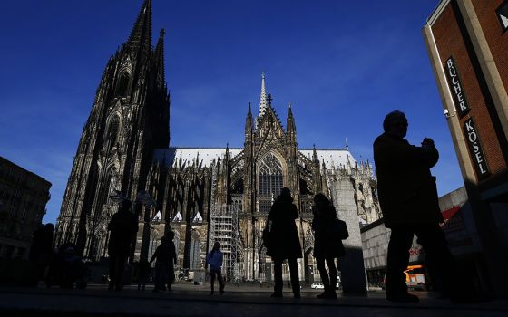 People are silhouetted against the Cologne Cathedral in Germany in 2016. (CNS/Reuters/Wolfgang Rattay)