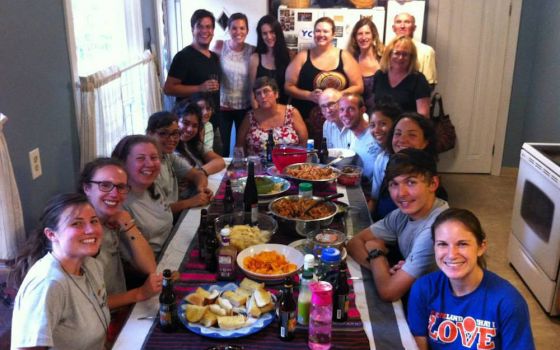 The Cleveland Jesuit Volunteer Corps family share a meal in this August 2015 photo. (Provided photo)