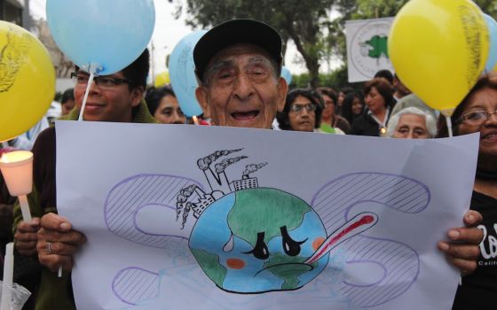 A man participates in an interfaith vigil before the 2014 U.N. climate summit in Lima, Peru. (Barbara Fraser)