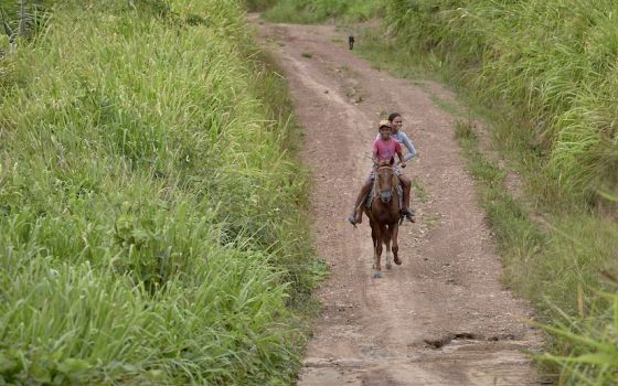 Two children ride a horse along a dirt road in the countryside near Anapu, in Brazil's northern Para state, where Sr. Dorothy Stang was murdered. Expansion of the agrarian frontier in recent decades has led to the steady destruction of this part of the Am