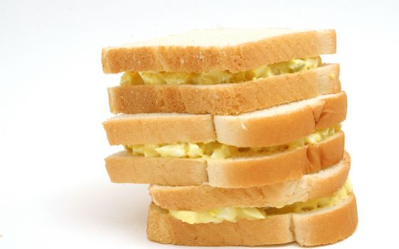 Stack of three egg salad sandwiches on white bread (Dreamstime/Andi Berger)