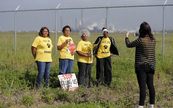 Members of Rise St. James conduct a livestream video on property owned by Formosa Plastics Group in St. James Parish, Louisiana, on March 11, 2020. (AP/Gerald Herbert)