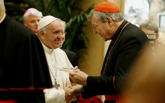 Pope Francis greets Australian Cardinal George Pell during an audience to exchange greetings with members of the Roman Curia in Clementine Hall of the Apostolic Palace at the Vatican Dec. 22, 2016. (CNS/Paul Haring)