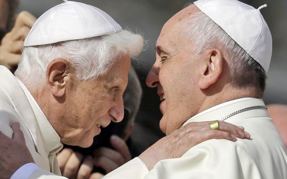 Pope Francis, right, hugs Pope Emeritus Benedict XVI prior to the start of a meeting with elderly faithful in St. Peter's Square at the Vatican, Sunday, Sept. 28, 2014. (AP Photo/Gregorio Borgia, File)