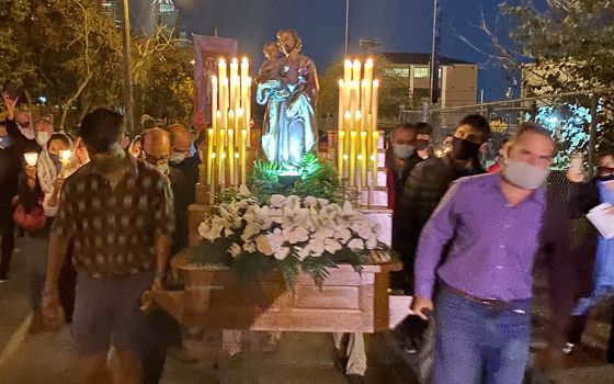 Several men carry a large statue of St. Joseph during the 2021 St. Joseph's Day procession hosted by St. Joseph Catholic Church in Houston. (Courtesy of Virginia Fraguio)