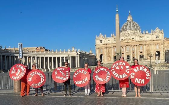 Women's ordination advocates pose outside St. Peter's Square as part of a witness on Aug. 29. (NCR photo/Christopher White)