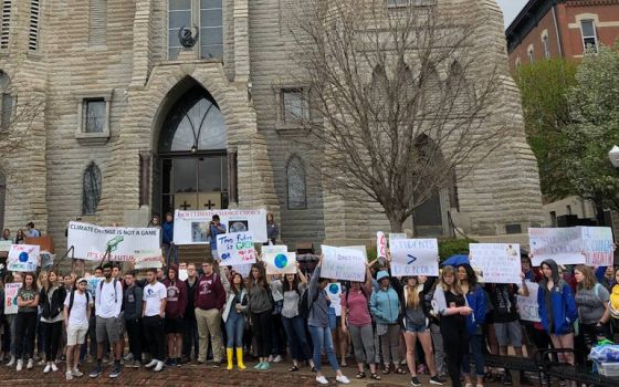 Hundreds of Creighton University students demonstrate outside St. John's Church on the Omaha, Nebraska campus in April pressing the Jesuit school to take increased action on climate change, including divesting its endowment from fossil fuels. (Emily Burke