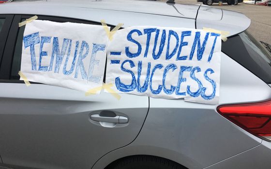 Signs adorn a car in an Oct. 18 alumni caravan protest against changes to the faculty handbook at John Carroll University in the Cleveland suburbs. (Courtesy of Kevin Henderson)