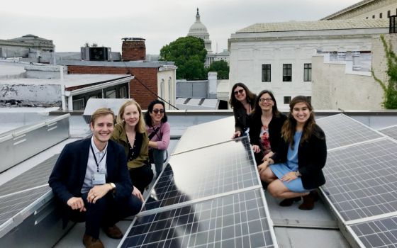 Members of Interfaith Power & Light pose near the solar panels on the roof of the Lutheran Church of the Reformation in Washington, D.C. (Interfaith Power & Light)