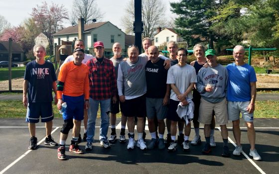 Jack McHale (center, black shirt) with friends at their weekly Sunday morning basketball games. McHale has recruited many of the men from these games to join on his trips into D.C. over the years. (Provided photo)