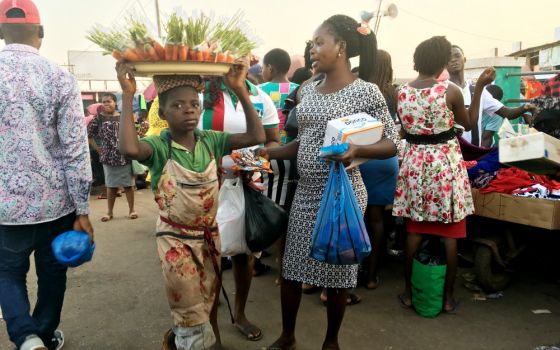A child hawks carrots at a market in Enugu State, Nigeria. (Patrick Egwu)