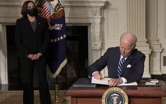 President Joe Biden, seated, signs "Executive Order on Tackling the Climate Crisis at Home and Abroad" Jan. 27, 2021. (NCR screenshot/The White House on YouTube)