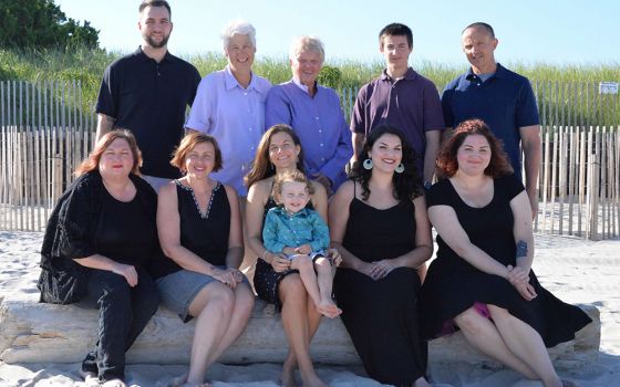 Honour Maddock and Kathleen Kane, standing second and third from the left, are pictured in a 2016 family photo with Kathleen's two daughters and son, their daughter-in-law and son-in-law, and their two granddaughters and two grandsons. (Courtesy photo)
