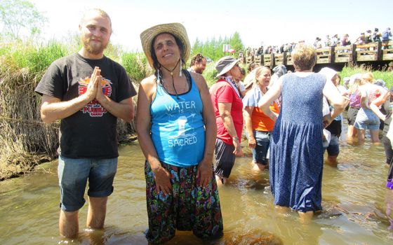 Indigenous activist and writer Winona LaDuke cools off with other protesters in the Mississippi River headwaters. (Claire Schaeffer-Duffy)