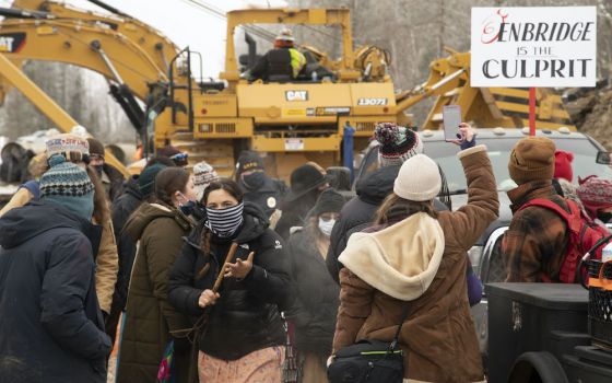Protesters surround construction equipment used to drill a path for the Enbridge Line 3 oil pipeline near Haypoint, Minnesota, Jan. 9, 2021. (© Keri Pickett)