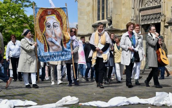 People in the Maria 2.0 movement protest outside Holy Cross Church in Münster, Germany, in May. (Ruth Koch)