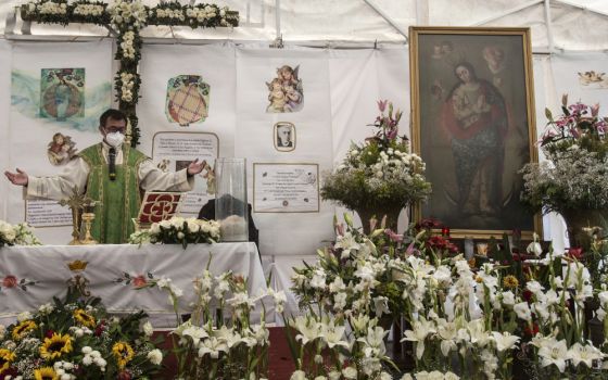 Fr. Adrian Vazquez celebrates an outdoor Mass under a white tent outside the quake-damaged Our Lady of the Angels Church, in the working-class Guerrero neighborhood of Mexico City Aug. 7. (AP/Ginnette Riquelme)