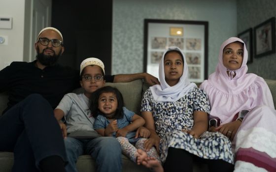 The Zakir family watches an episode of "Ms. Marvel" in Anaheim, California, on July 8. From left: father Yusuf; son Burhanuddin; Yusuf's niece, Insiya Maimoon; daughter Jumana; and mother Fareeda (AP Photo/Jae C. Hong)