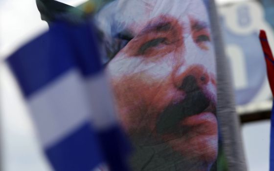 A banner emblazoned with an image of Nicaragua's President Daniel Ortega is waved by an Ortega supporter in Managua, Nicaragua, April 30, 2018. (AP file/Alfredo Zuniga)