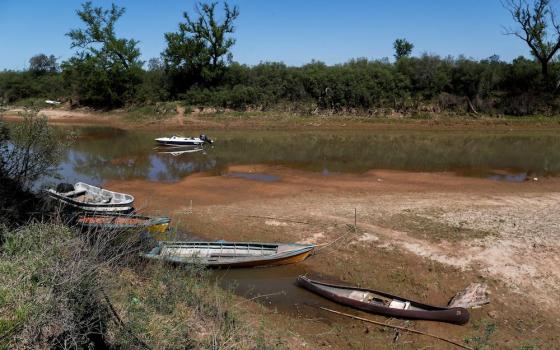 Stranded boats are seen on the waters of a dried branch of the Paraná River at the delta islands near Rosario, Argentina, in September. The lack of water in the Paraná is forcing fishing communities to move, while deforestation in the Amazon is disrupting