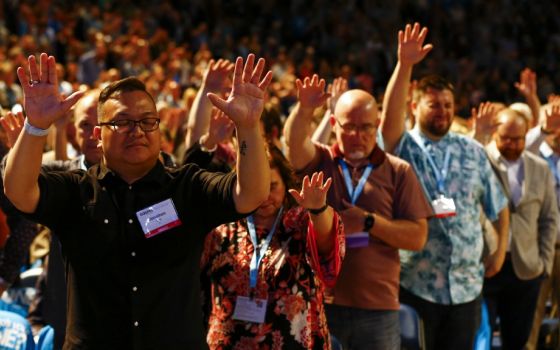 Members of the Southern Baptist Convention and guests lift their hands in prayer during the SBC's annual meeting in Birmingham, Alabama, June 11. (RNS/Butch Dill)