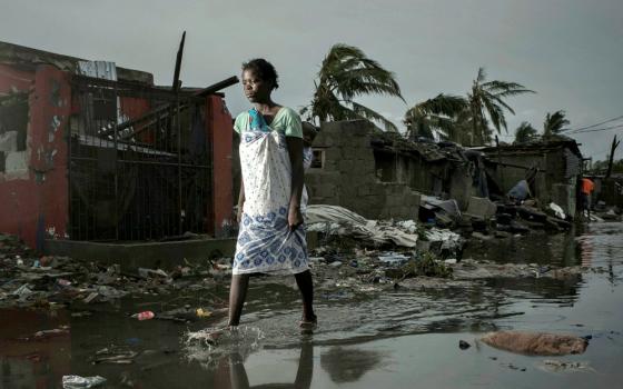 A young woman walks through floodwaters March 17 in the aftermath of Cyclone Idai in Beira, Mozambique. More than 600 died in Mozambique after a cyclone slammed into the country, submerging entire villages. (CNS/Reuters/Care International/Josh Estey)