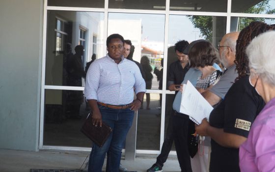 DeAndress Green, left, debriefs with leaders of Metro Congregations United after a meeting of the Missouri Air Conservation Commission in St. Louis. (RNS Photo/Britny Cordera)