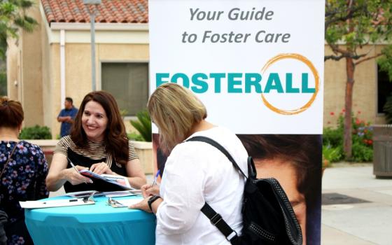 Noemi Amezcua, left, works to recruit potential foster families for FosterAll outside St. Elizabeth Ann Seton Church, a parish within the Los Angeles Archdiocese, on Father’s Day, June 16. (RNS/Heather Adams)