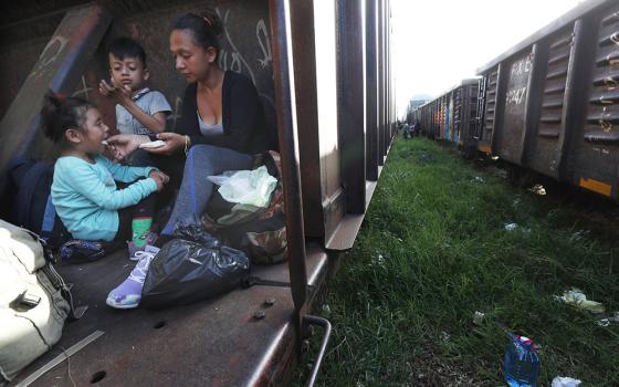 A migrant mother and children ride a freight train on their journey north, on June 24, 2019, in Palenque, Chiapas state, Mexico. (RNS/AP photo/Marco Ugarte)