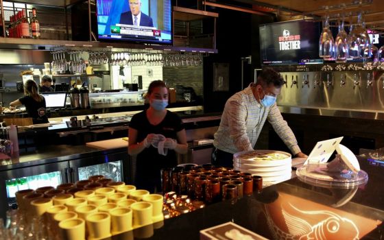 People in Miami work at a restaurant Aug. 31 during the coronavirus pandemic. (CNS/Reuters/Marco Bello)