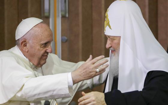 Pope Francis, left, reaches to embrace Russian Orthodox Patriarch Kirill in Havana, Cuba Feb. 12, 2016. (AP Photo/Gregorio Borgia, Pool)