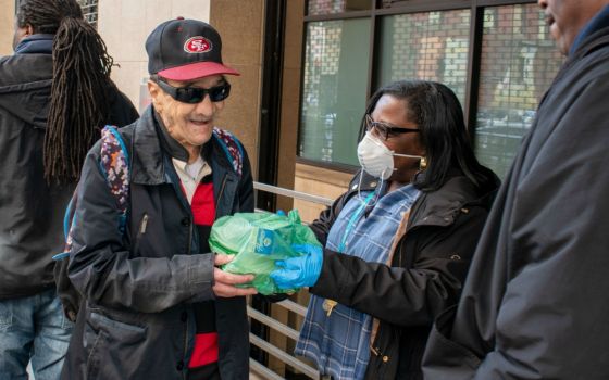 Volunteers hand out meals to homeless people in the community at St. Anthony's in San Francisco's Tenderloin district. (Provided photo)