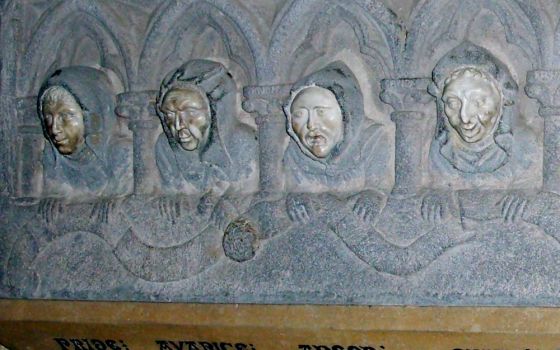 The faces of monks illustrate deadly sins in this detail from a circa 1300 sculpture. (Wikimedia Commons/Simon Burchell)