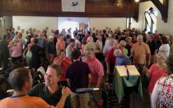 Parishioners of St. William Catholic Community in Louisville, Kentucky, share the sign of peace at Mass. (Courtesy of St. William Catholic Community)