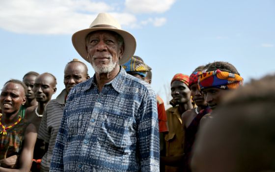 Morgan Freeman stands with villagers during an Ethiopian Peace Ceremony in Omo Valley, Ethiopia, in an episode of "The Story of Us." (National Geographic/Maria Bohe)