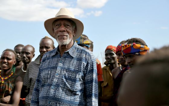 Morgan Freeman stands with villagers during an Ethiopian Peace Ceremony in Omo Valley, Ethiopia, in an episode of "The Story of Us." (National Geographic/Maria Bohe)
