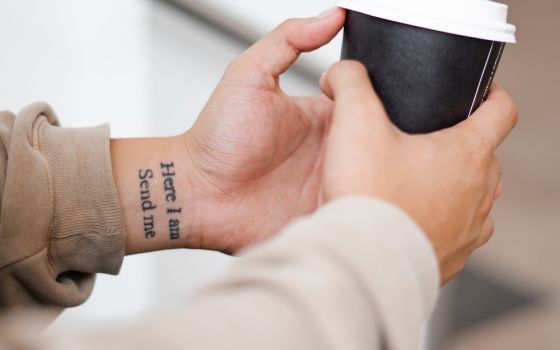 Tattoo on wrist that says "Here I am / Send me" (Unsplash/Kelli McClintock)