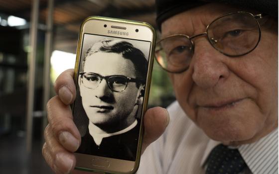 Jose Barba shows a photo of himself when he was a 18-year-old seminarian student, Mexico City, Feb. 22, 2022. (AP Photo/Marco Ugarte)