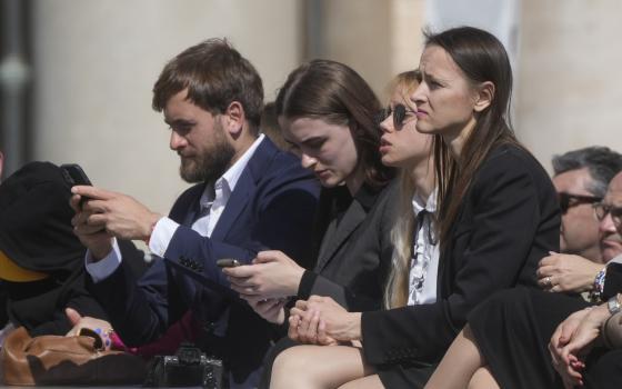 Kateryna Prokopenko, center, wife of Azov Commander Denys Prokopenko, and Yuliia Fedosiuk, second from left, from Ukraine attend Pope Francis weekly general audience in St. Peter's Square at the Vatican, Wednesday, May 11, 2022. (AP Photo/Gregorio Borgia)