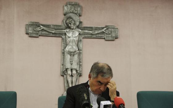 Cardinal Angelo Becciu talks to journalists during press conference in Rome, in this Friday, Sept. 25, 2020. (AP Photo/Gregorio Borgia)