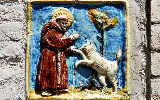 A tile in Assisi, Italy, depicts St. Francis and the wolf of Gubbio. (Wikimedia Commons/Zorro2212)