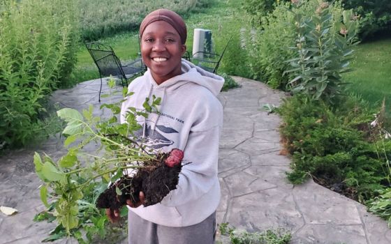 Ylanda Wilhite, photographed by her mother, Lisa, holding home grown potatoes in the back yard. (Courtesy of Lisa Wilhite)